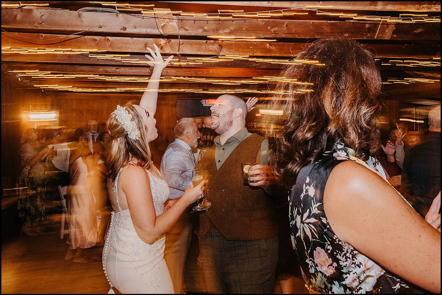 A bride and groom sing along to a song at their wedding reception.