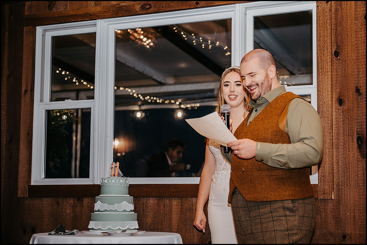 A groom reads a speech from a sheet of paper.