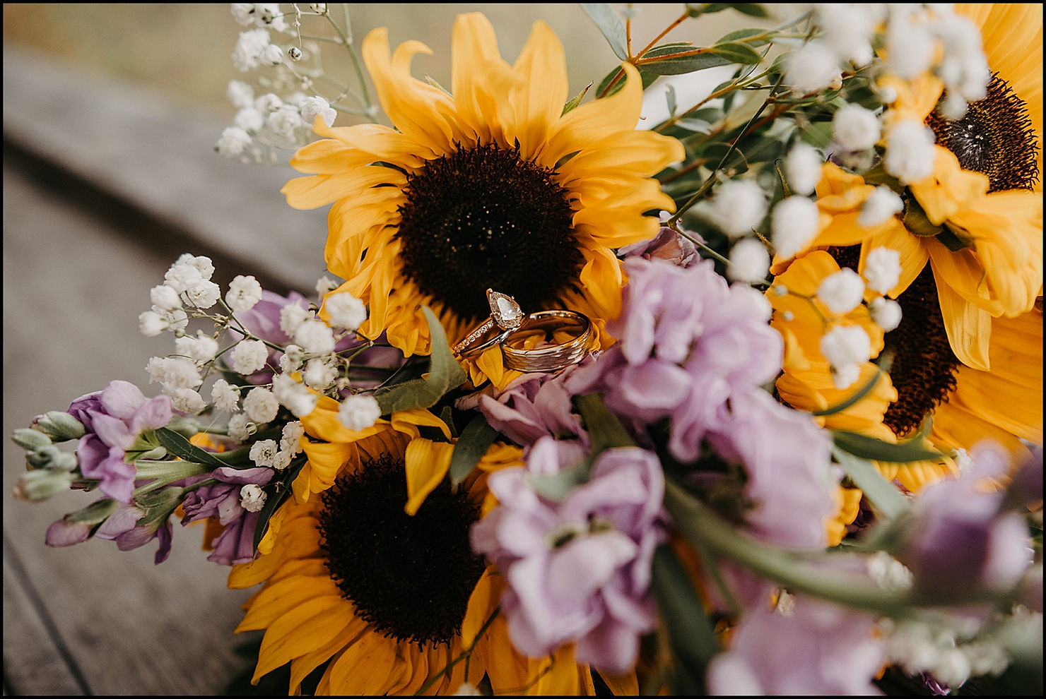 Wedding rings sit nestled in a bridal bouquet at a Cape Cod wedding.