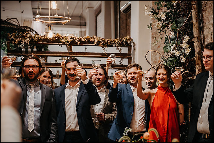 Wedding guests raise their glasses at the end of a toast at Maman Tribeca.