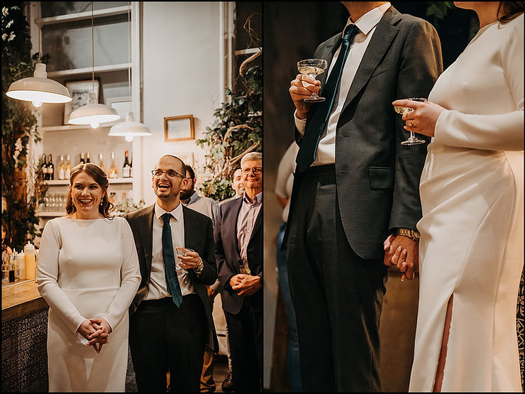 A bride and groom stand laughing beside a tiled bar in Maman Tribeca, a New York City wedding venue.